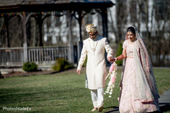 Indian bride and groom walking outdoors Indian bride and groom walking outdoors