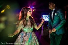 Indian couple dancing during reception party. Indian couple dancing during reception party.