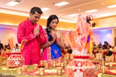 Indian bride and groom making prayers to their gods at sangeet. Indian bride and groom making prayers to their gods at sangeet.