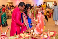 Indian couple lighting up the fire at sangeet altar. Indian couple lighting up the fire at sangeet altar.