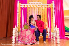 Indian couple posing on the sangeet swing seat. Indian couple posing on the sangeet swing seat.