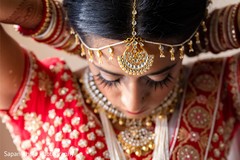 Indian bride getting her kundan necklace on. Indian bride getting her kundan necklace on.