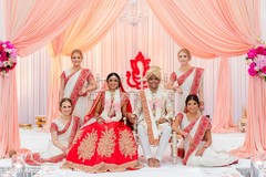 Indian couple posing with bridesmaids at mandap. Indian couple posing with bridesmaids at mandap.