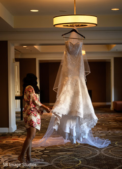Indian bride admiring her wedding dress. Indian bride admiring her wedding dress.