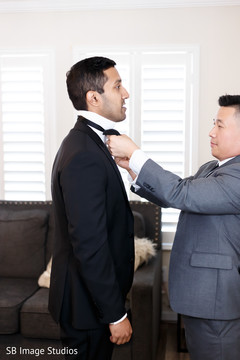 Indian groom being helped to get ready. Indian groom being helped to get ready.