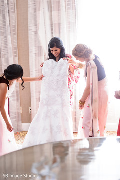 Indian bride about to put her white dress on. Indian bride about to put her white dress on.