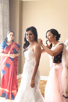 Indian bride being helped to get ready. Indian bride being helped to get ready.