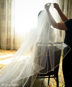 Indian bride putting her veil on. Indian bride putting her veil on.