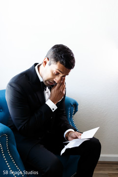 Indian groom reading bridal postcard. Indian groom reading bridal postcard.