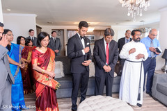 Indian groom and family making a prayer. Indian groom and family making a prayer.