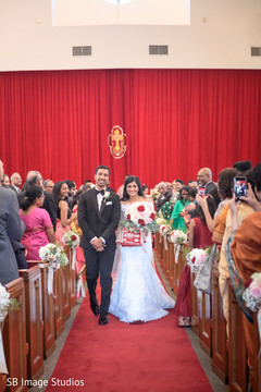 Indian couple walking out at ceremony aisle. Indian couple walking out at ceremony aisle.