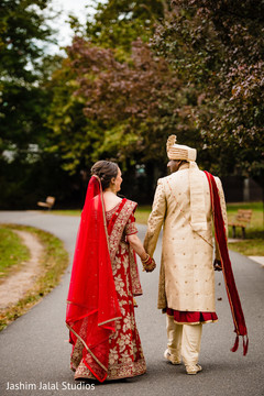 Indian bride and groom walking outdoors Indian bride and groom walking outdoors