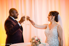 Indian bride and groom making a toast Indian bride and groom making a toast