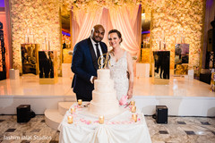 Lovely newlyweds posing by the cake Lovely newlyweds posing by the cake
