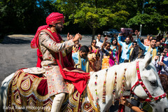 Charming Indian groom riding his white baraat horse. Charming Indian groom riding his white baraat horse.