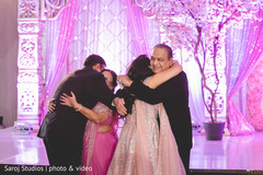 Indian bride and groom hugging the special guests Indian bride and groom hugging the special guests