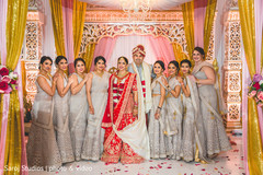 Indian bridesmaids posing with bride and groom Indian bridesmaids posing with bride and groom