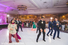 Indian groom performing with groomsmen Indian groom performing with groomsmen