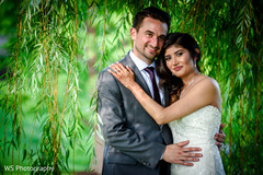 Sweet Indian couple posing on their reception outfits. Sweet Indian couple posing on their reception outfits.