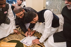 Indian groom signing his wedding certificate. Indian groom signing his wedding certificate.