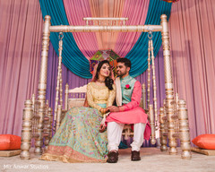Indian couple posing on their sangeet stage. Indian couple posing on their sangeet stage.