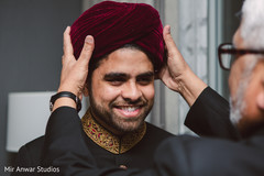 Indian groom getting his turban on. Indian groom getting his turban on.