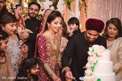 Indian groom about to give cake to bride. Indian groom about to give cake to bride.