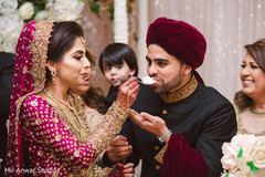 Indian bride giving cake to groom. Indian bride giving cake to groom.