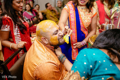 Charming Indian groom getting yellow turmeric paste all over. Charming Indian groom getting yellow turmeric paste all over.