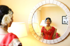 Enchanting Indian bride looking in mirror. Enchanting Indian bride looking in mirror.