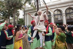 Indian groom being lifted by special guests Indian groom being lifted by special guests