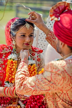 Indian groom putting the red mark on bride forehead. Indian groom putting the red mark on bride forehead.