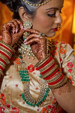 Indian bride putting her earrings on. Indian bride putting her earrings on.
