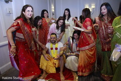 Indian groom with bridesmaids at haldi ritual. Indian groom with bridesmaids at haldi ritual.