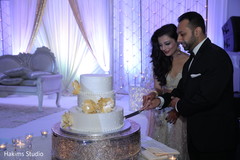 Lovely capture Indian bride and groom cutting cake together. Lovely capture Indian bride and groom cutting cake together.