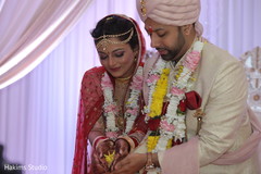 Indian couple pouring rice to the Sacred Fire. Indian couple pouring rice to the Sacred Fire.