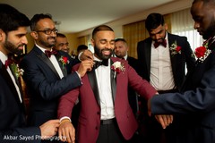 Indian groom being assisted by groomsmen Indian groom being assisted by groomsmen