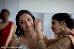 Indian bride being assisted by bridesmaids Indian bride being assisted by bridesmaids