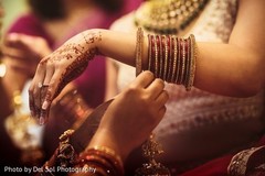 Indian bride putting her ceremony choora. Indian bride putting her ceremony choora.