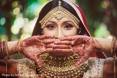 Indian bride with mehndi art, tikka, kundan and engagement ring. Indian bride with mehndi art, tikka, kundan and engagement ring.