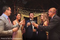 Indian couple having cheers with guests. Indian couple having cheers with guests.