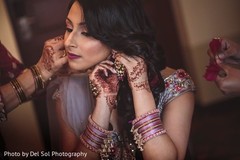 Maharani putting her sangeet earring on. Maharani putting her sangeet earring on.