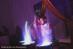 Closeup capture of drum player at sangeet celebration. Closeup capture of drum player at sangeet celebration.