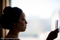 Indian bride looking on an mirror. Indian bride looking on an mirror.