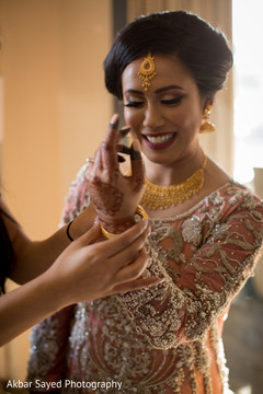 Indian bride putting her choora on. Indian bride putting her choora on.