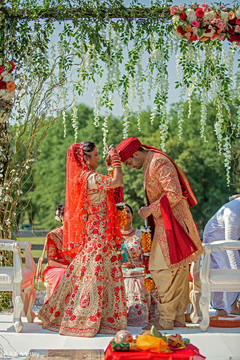Indian bride putting garland to groom. Indian bride putting garland to groom.