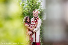 Indian bride and groom posing for pictures Indian bride and groom posing for pictures