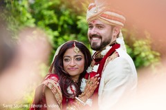 Indian bride and groom posing for pictures Indian bride and groom posing for pictures