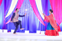 Indian bride and groom dancing at sangeet stage. Indian bride and groom dancing at sangeet stage.