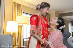 Sweet indian bride's mother helping her to get ready. Sweet indian bride's mother helping her to get ready.